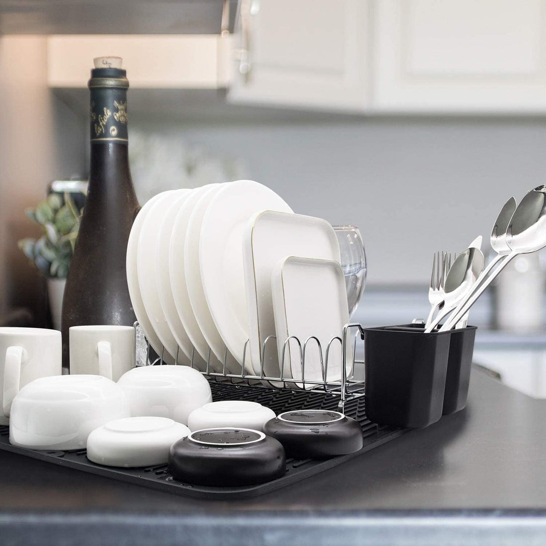 Essential kitchen utensils including frying pan, spatula, whisk, and tongs for home cooking